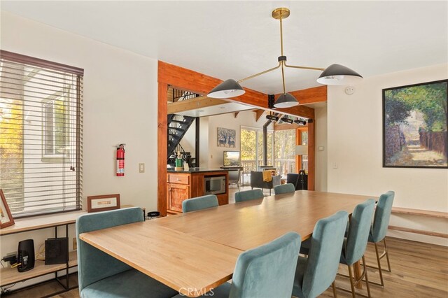 217 Crest Cir, Lake Arrowhead, CA 92352 - dining room featuring a baseboard heating unit, wood finished floors, a dry bar, and baseboards