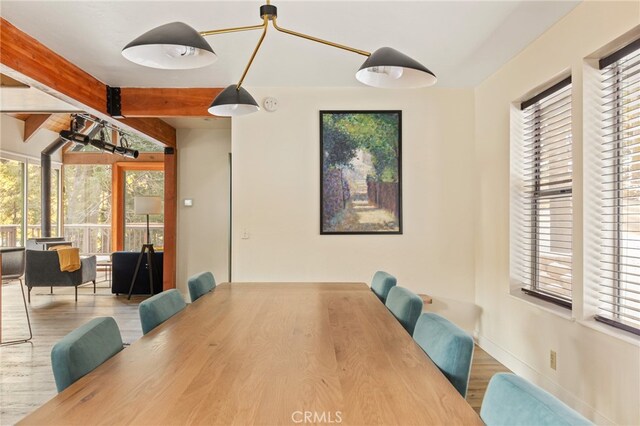 217 Crest Cir, Lake Arrowhead, CA 92352 - dining room with beam ceiling, healthy amount of natural light, wood finished floors, and baseboards