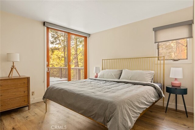 217 Crest Cir, Lake Arrowhead, CA 92352 - bedroom featuring access to outside, wood finished floors, and baseboards