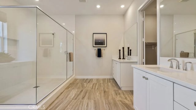 27225 Cranmore Way Unit 302, Valencia, CA 91381 - bathroom with a stall shower, two vanities, and recessed lighting