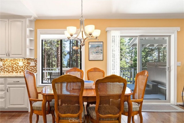 720 E Mountain Ridge Rd, Lake Almanor, CA 96137 - dining space featuring a chandelier, healthy amount of natural light, and wood finished floors