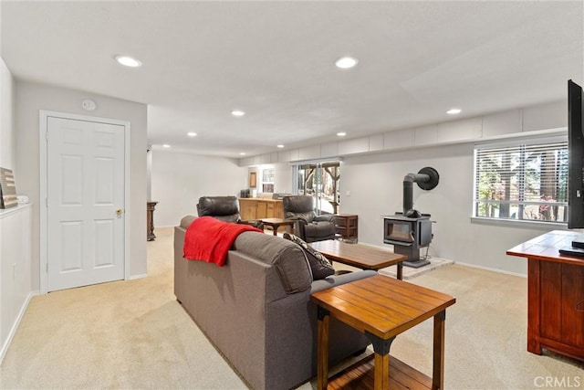 720 E Mountain Ridge Rd, Lake Almanor, CA 96137 - living room with light colored carpet, recessed lighting, a wood stove, baseboards, and plenty of natural light