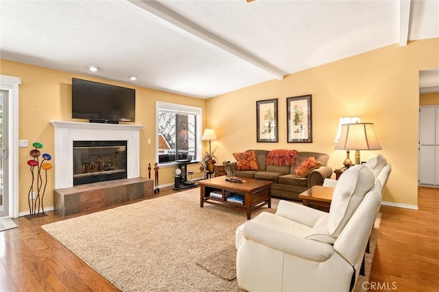 720 E Mountain Ridge Rd, Lake Almanor, CA 96137 - living area with beamed ceiling, wood finished floors, a fireplace, baseboards, and recessed lighting