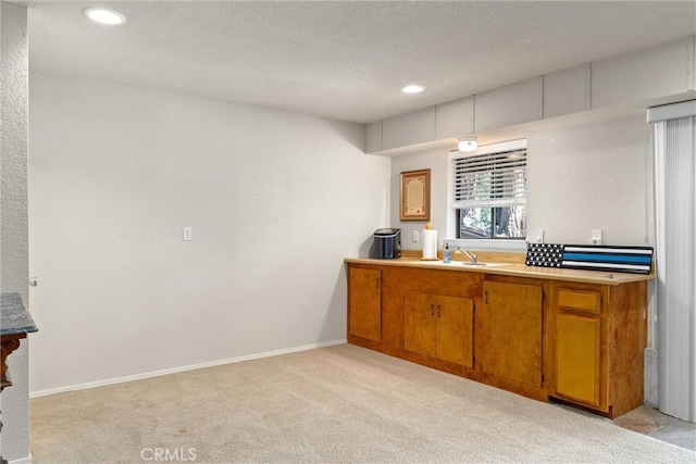 720 E Mountain Ridge Rd, Lake Almanor, CA 96137 - kitchen with brown cabinets, light carpet, a sink, recessed lighting, and a textured ceiling