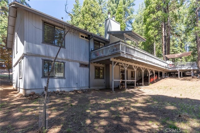 720 E Mountain Ridge Rd, Lake Almanor, CA 96137 - back of house with a wooden deck and a chimney