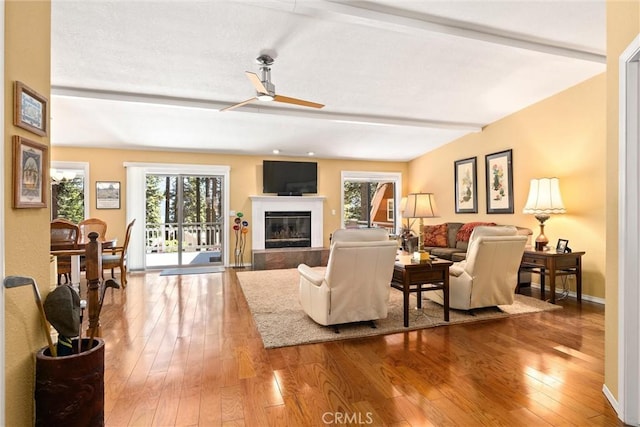 720 E Mountain Ridge Rd, Lake Almanor, CA 96137 - living room with ceiling fan, a glass covered fireplace, wood-type flooring, plenty of natural light, and beam ceiling