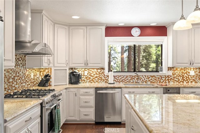 720 E Mountain Ridge Rd, Lake Almanor, CA 96137 - kitchen with stainless steel appliances, wall chimney range hood, a sink, white cabinetry, and a textured ceiling