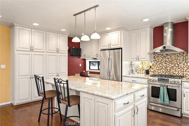 720 E Mountain Ridge Rd, Lake Almanor, CA 96137 - kitchen featuring appliances with stainless steel finishes, wall chimney exhaust hood, dark wood-style floors, a center island, and backsplash