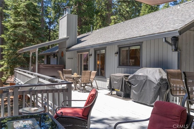 720 E Mountain Ridge Rd, Lake Almanor, CA 96137 - wooden deck with a hot tub, a grill, outdoor dining area, and a patio