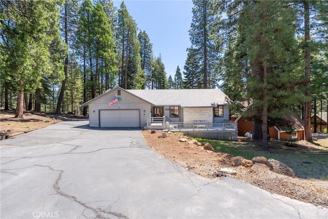 720 E Mountain Ridge Rd, Lake Almanor, CA 96137 - ranch-style home featuring asphalt driveway and an attached garage