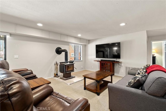 720 E Mountain Ridge Rd, Lake Almanor, CA 96137 - living room featuring light colored carpet, a wood stove, recessed lighting, baseboards, and a textured ceiling