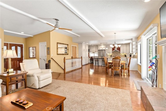 720 E Mountain Ridge Rd, Lake Almanor, CA 96137 - living area with light wood finished floors, a ceiling fan, recessed lighting, beamed ceiling, and a chandelier