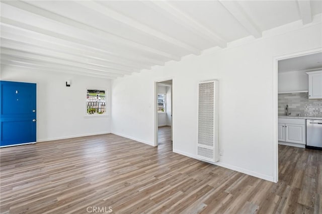 295 Wave St, Laguna Beach, CA 92651 - unfurnished living room with a heating unit, light wood finished floors, beamed ceiling, a sink, and baseboards