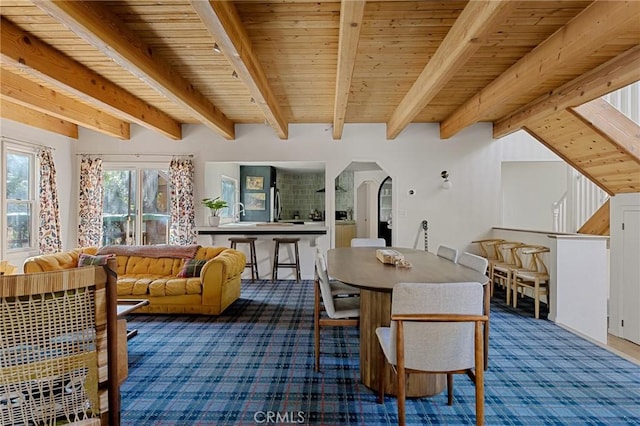 951 Osprey Ln, Lake Arrowhead, CA 92352 - carpeted dining room with arched walkways and wood ceiling with exposed beams