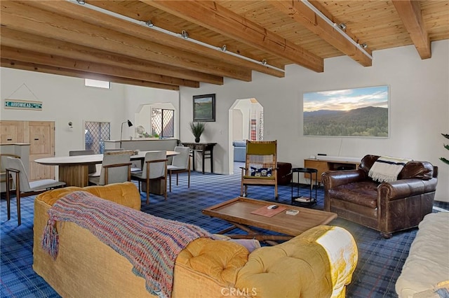 951 Osprey Ln, Lake Arrowhead, CA 92352 - carpeted living area featuring arched walkways and wood ceiling with exposed beams
