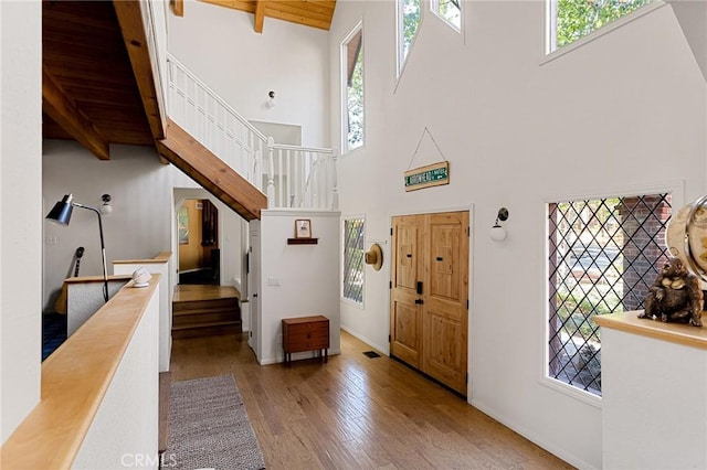 951 Osprey Ln, Lake Arrowhead, CA 92352 - foyer entrance with wood finished floors, a towering ceiling, stairs, baseboards, and wooden ceiling with exposed beams
