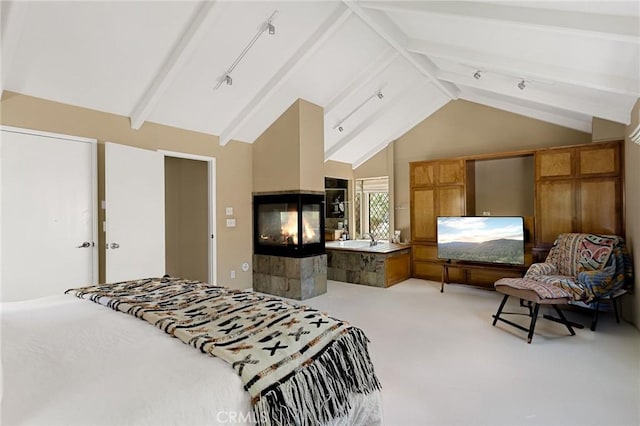 951 Osprey Ln, Lake Arrowhead, CA 92352 - bedroom with light colored carpet, beamed ceiling, a multi sided fireplace, rail lighting, and high vaulted ceiling