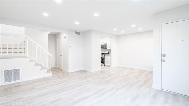 12302 Runnymede St Unit 4, North Hollywood, CA 91605 - unfurnished living room with stairway, light wood finished floors, recessed lighting, and baseboards