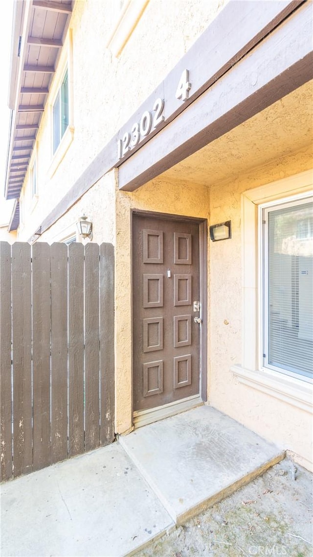 12302 Runnymede St Unit 4, North Hollywood, CA 91605 - doorway to property featuring stucco siding and a gate