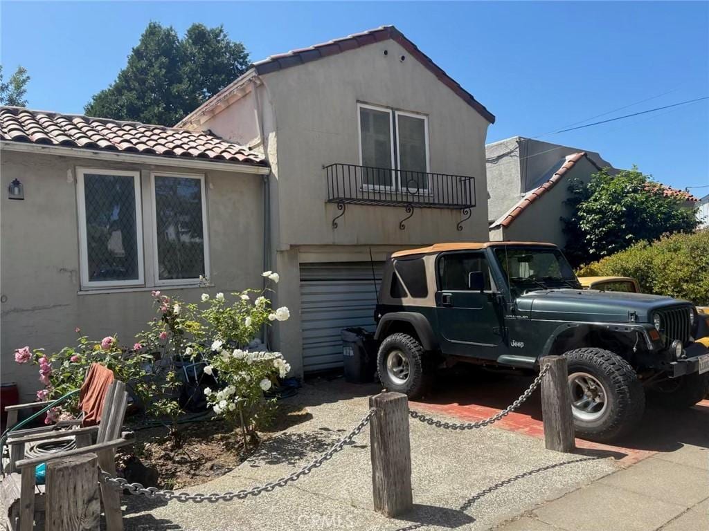 720 Ky Route Blvd, Albany, CA 94706 - mediterranean / spanish-style home featuring a tiled roof, stucco siding, a garage, and driveway