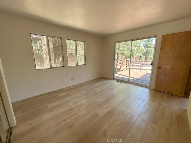 1928 Wilderness Rd, Running Springs, CA 92382 - unfurnished room with light wood-type flooring and a textured ceiling