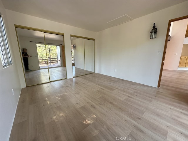 1928 Wilderness Rd, Running Springs, CA 92382 - unfurnished bedroom with two closets and light wood-type flooring