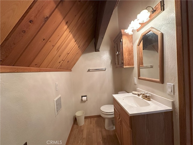 1928 Wilderness Rd, Running Springs, CA 92382 - bathroom featuring toilet, wood finished floors, vanity, baseboards, and vaulted ceiling