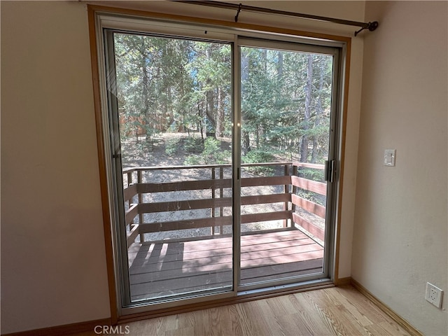 1928 Wilderness Rd, Running Springs, CA 92382 - doorway featuring healthy amount of natural light, baseboards, and wood finished floors