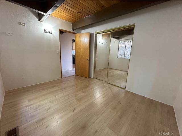 1928 Wilderness Rd, Running Springs, CA 92382 - unfurnished bedroom featuring light wood-type flooring, wooden ceiling with exposed beams, and a closet