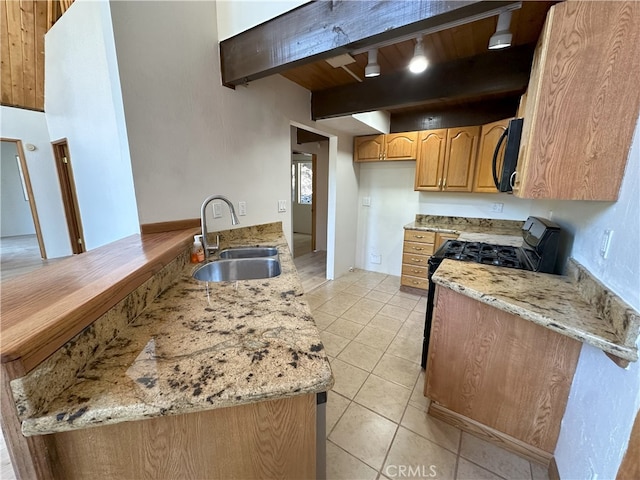 1928 Wilderness Rd, Running Springs, CA 92382 - kitchen featuring a sink, black microwave, range with gas stovetop, beamed ceiling, and light tile patterned floors
