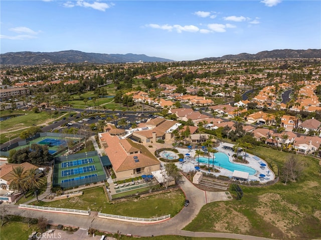 23981 Via Astuto, Murrieta, CA 92562 - aerial overview of property's location featuring a mountain backdrop, a pool area, and nearby suburban area