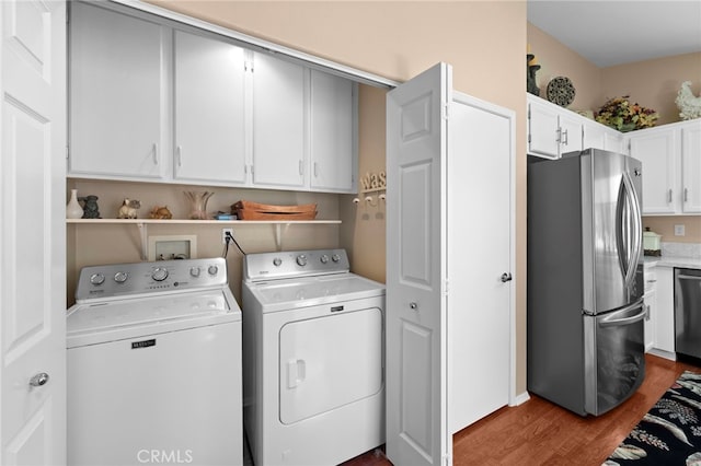 23981 Via Astuto, Murrieta, CA 92562 - laundry room featuring washing machine and dryer and dark wood-style floors