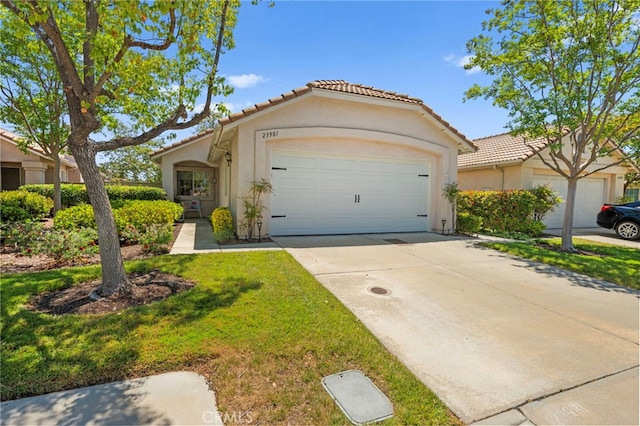23981 Via Astuto, Murrieta, CA 92562 - view of front of property with a tiled roof, stucco siding, an attached garage, concrete driveway, and a front lawn