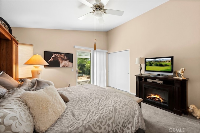 23981 Via Astuto, Murrieta, CA 92562 - carpeted bedroom with access to outside, ceiling fan, a glass covered fireplace, and vaulted ceiling