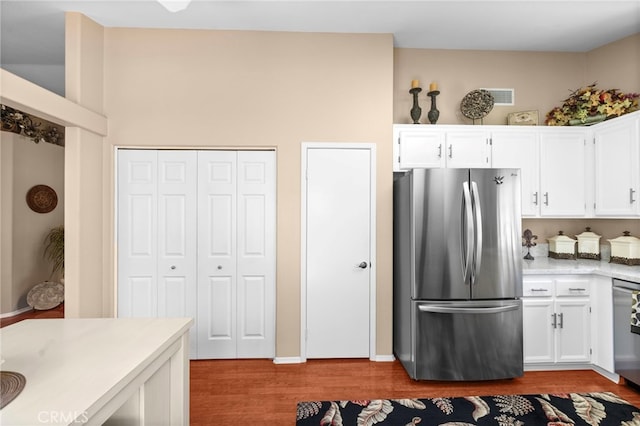 23981 Via Astuto, Murrieta, CA 92562 - kitchen with stainless steel appliances, dark wood finished floors, white cabinetry, and light countertops