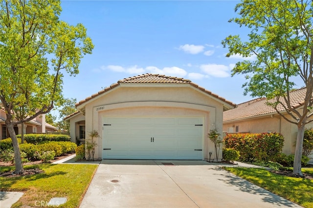 23981 Via Astuto, Murrieta, CA 92562 - mediterranean / spanish home featuring driveway, a tile roof, stucco siding, and an attached garage