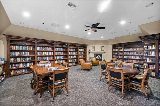 23981 Via Astuto, Murrieta, CA 92562 - dining area featuring carpet floors, ceiling fan, a lit fireplace, and recessed lighting