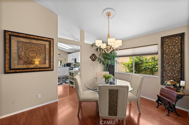 23981 Via Astuto, Murrieta, CA 92562 - dining area featuring a chandelier, wood finished floors, baseboards, and lofted ceiling