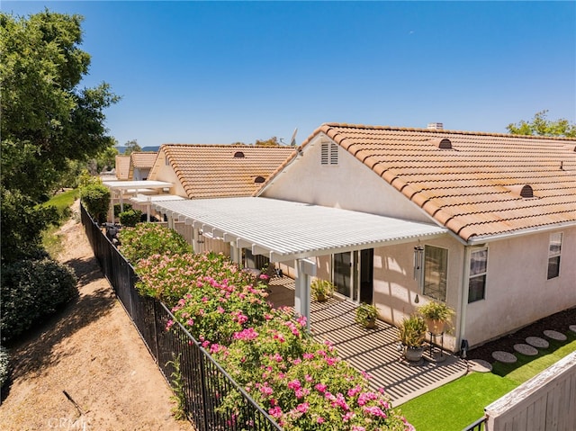 23981 Via Astuto, Murrieta, CA 92562 - back of property featuring a pergola, a tiled roof, stucco siding, and a patio