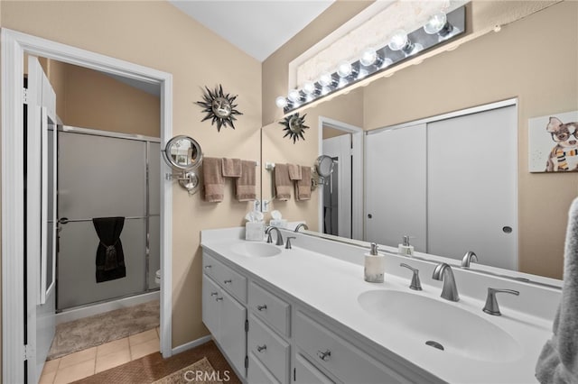 23981 Via Astuto, Murrieta, CA 92562 - full bath with double vanity, a shower stall, tile patterned flooring, and toilet