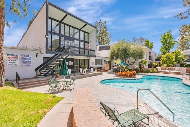 18645 Hatteras St Unit 203, Tarzana, CA 91356 - community pool featuring stairs and a patio