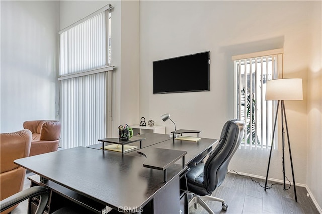 18645 Hatteras St Unit 203, Tarzana, CA 91356 - home office featuring baseboards, a towering ceiling, and wood finished floors