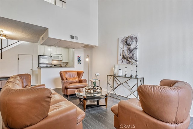 18645 Hatteras St Unit 203, Tarzana, CA 91356 - living area featuring a high ceiling, dark wood finished floors, and baseboards