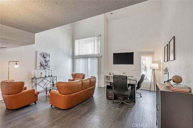 18645 Hatteras St Unit 203, Tarzana, CA 91356 - living area with dark wood-style floors, healthy amount of natural light, an office area, a textured ceiling, and a towering ceiling