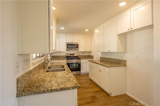 15156 Kinai Rd, Apple Valley, CA 92307 - kitchen with stainless steel appliances, a sink, recessed lighting, light stone counters, and white cabinetry