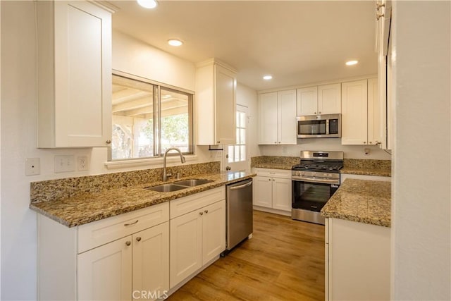 15156 Kinai Rd, Apple Valley, CA 92307 - kitchen with stainless steel appliances, a sink, white cabinetry, and recessed lighting