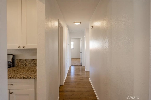15156 Kinai Rd, Apple Valley, CA 92307 - hallway with dark wood-style flooring and baseboards
