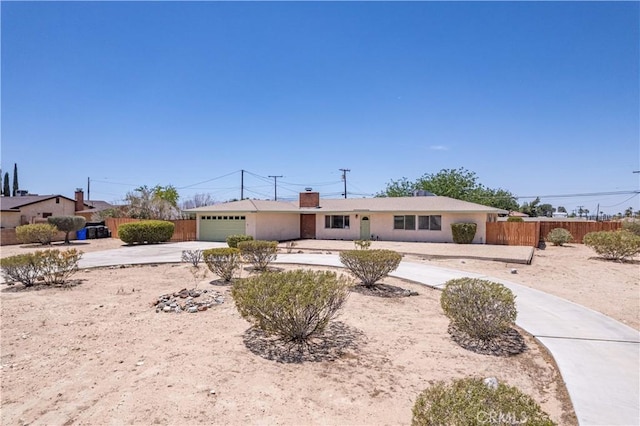 15156 Kinai Rd, Apple Valley, CA 92307 - ranch-style house featuring concrete driveway, a garage, a chimney, and stucco siding