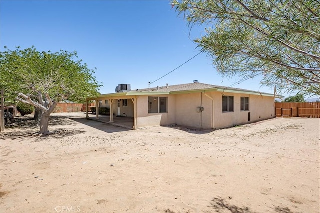 15156 Kinai Rd, Apple Valley, CA 92307 - back of property featuring a fenced backyard, a patio, stucco siding, and central AC unit