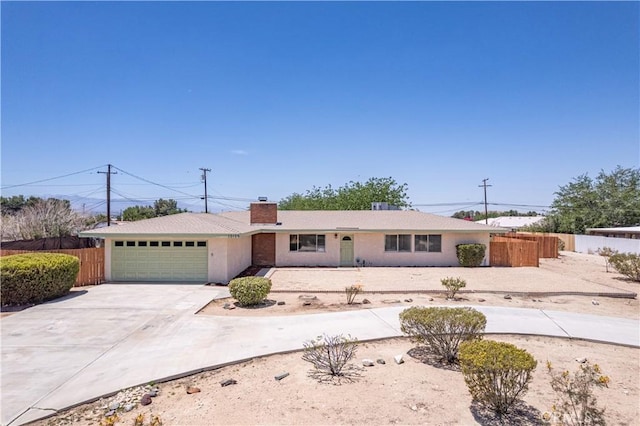 15156 Kinai Rd, Apple Valley, CA 92307 - ranch-style house with concrete driveway, a garage, and a chimney